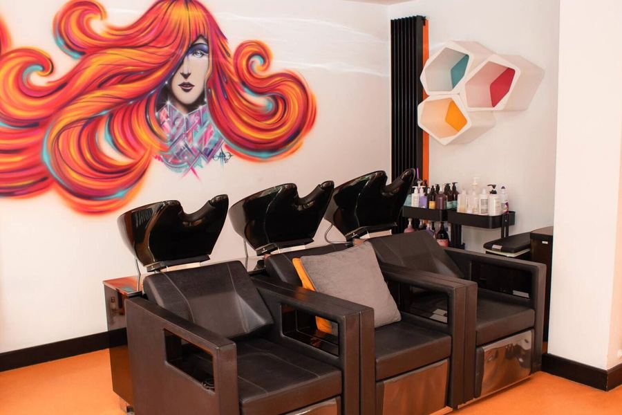 Inside C W Hair & Beauty: colourful mural and backwash basins